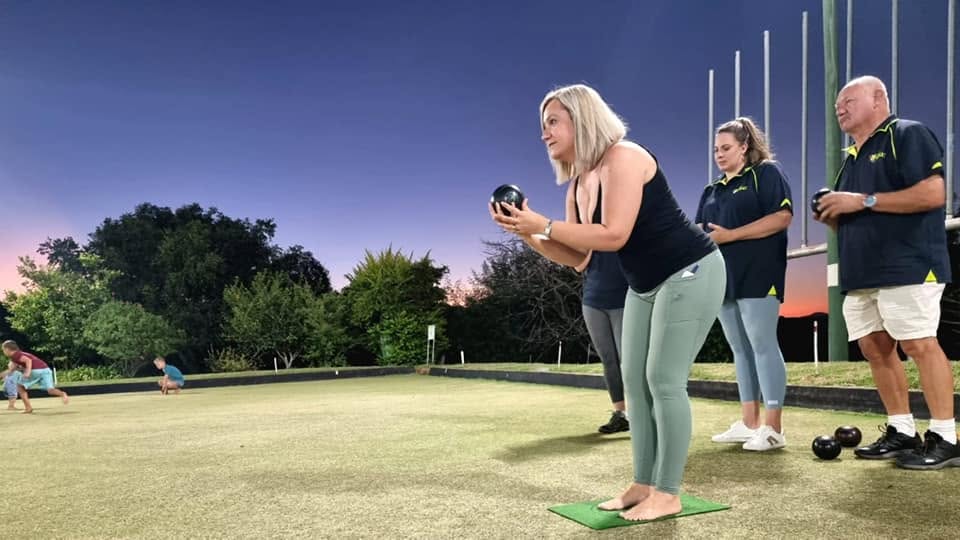 A member preparing to bowl on the green