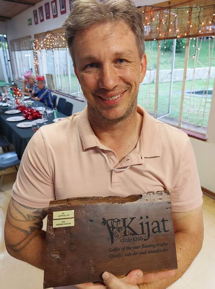 A Kijat golfer with the club trophy