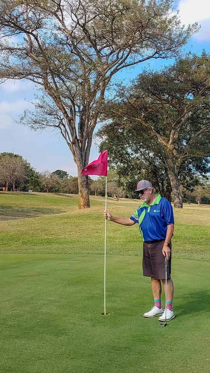A Kijat golfer beside the pin on the green